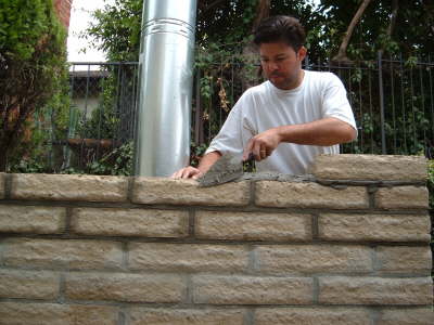 Mason working on oven surround
