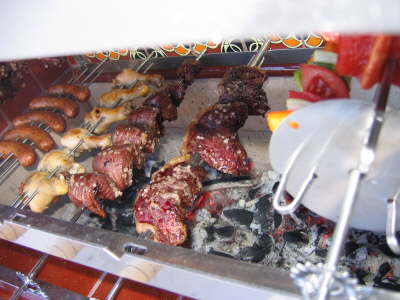 Sausage, chicken drumsticks, skirt steak and sirloin cap (picanha)