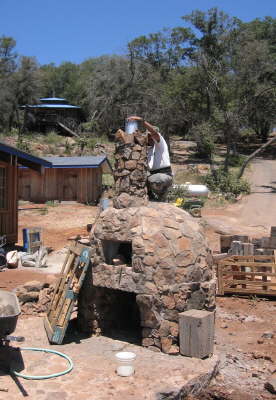 Mason working on oven chimeny